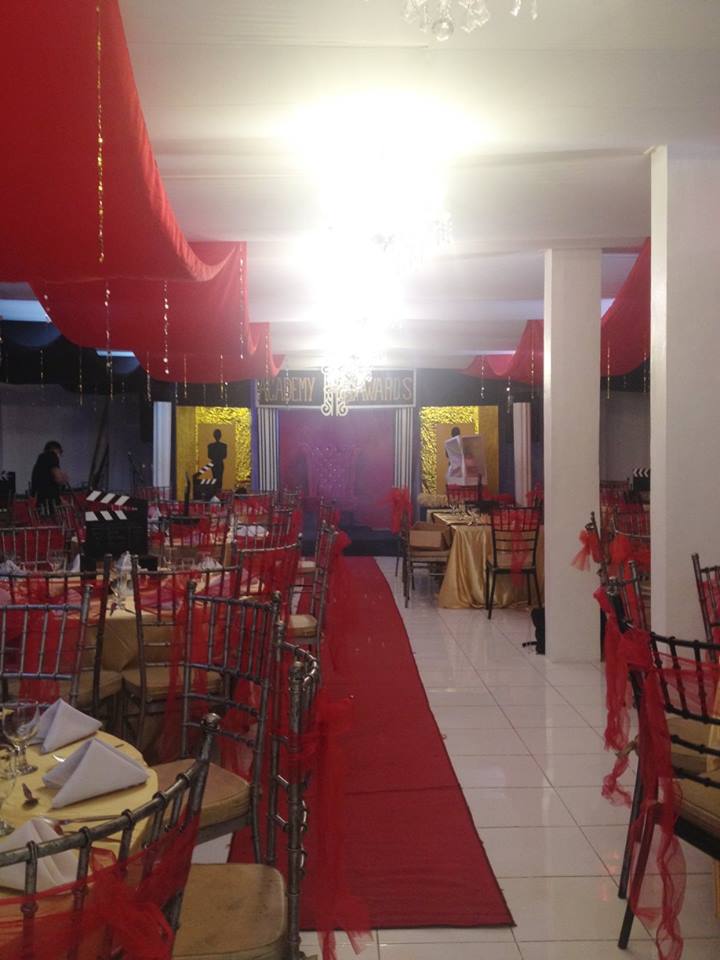 Event venue with red carpet and tiffany chairs