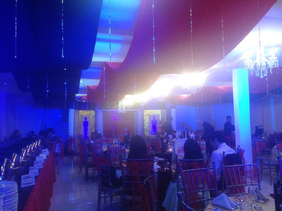 Hollywood theme event decoration with red and yellow as main colors, and added blue lights