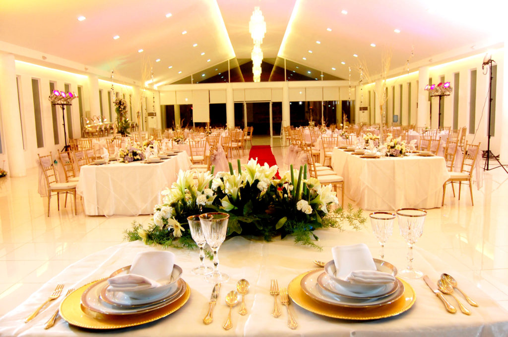 Event venue decorated with elegant white flowers and white ambient lights