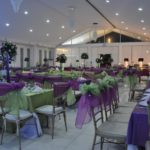Event venue decorated with lavender color theme and flower arrangements